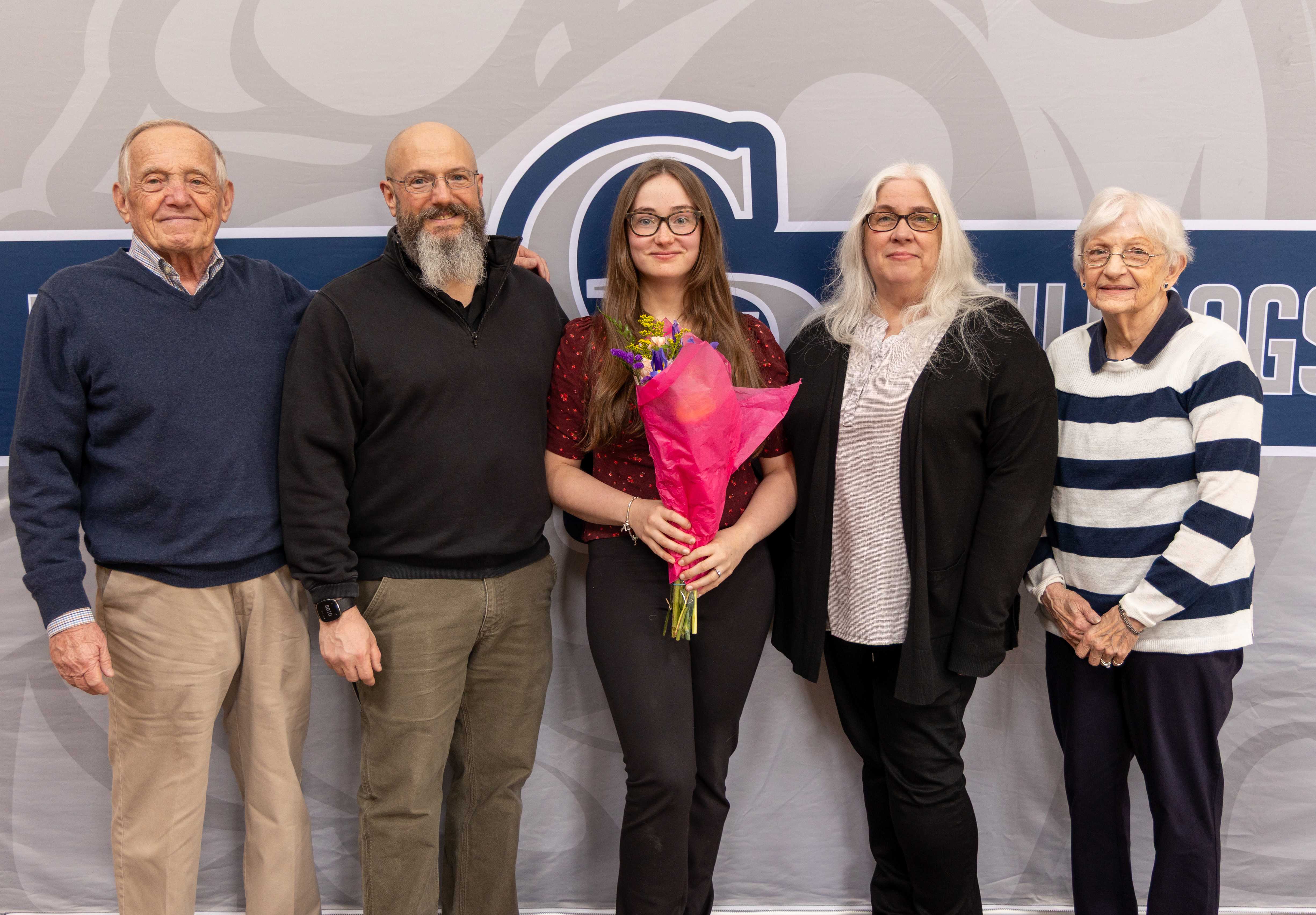 Abigail Smith poses with her parents, Melinda and Eric, and grandparents